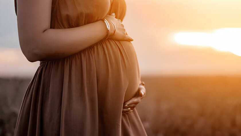 Pregnant woman at sunset, preparing for having a baby