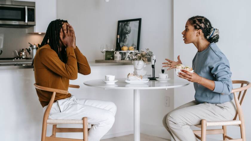 Couple having a calm money conversation at the kitchen table