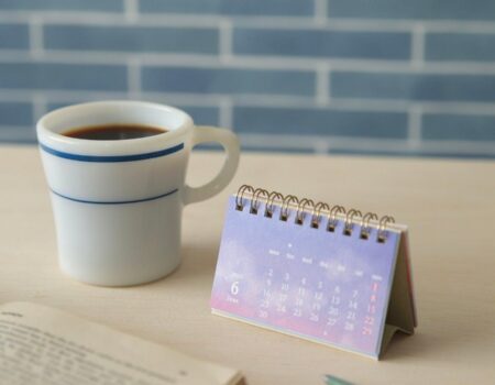 June calendar, notebook and coffee representing a mid-year financial reset with an accountant in Motueka budgeting review