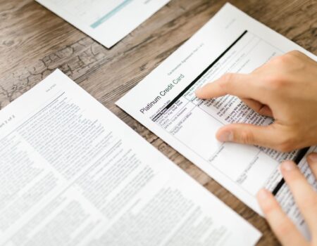 Person conducting a personal finance review by checking subscriptions, recurring expenses, and budgeting plans with guidance from an accountant in Motueka.