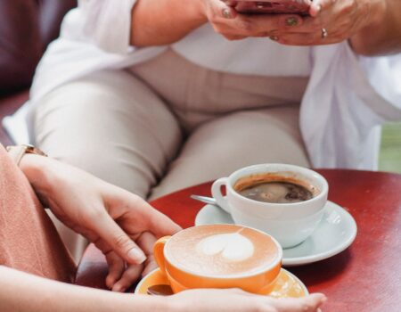 A woman sitting in a café by a window holding a coffee cup in Accountant in Motueka prospective